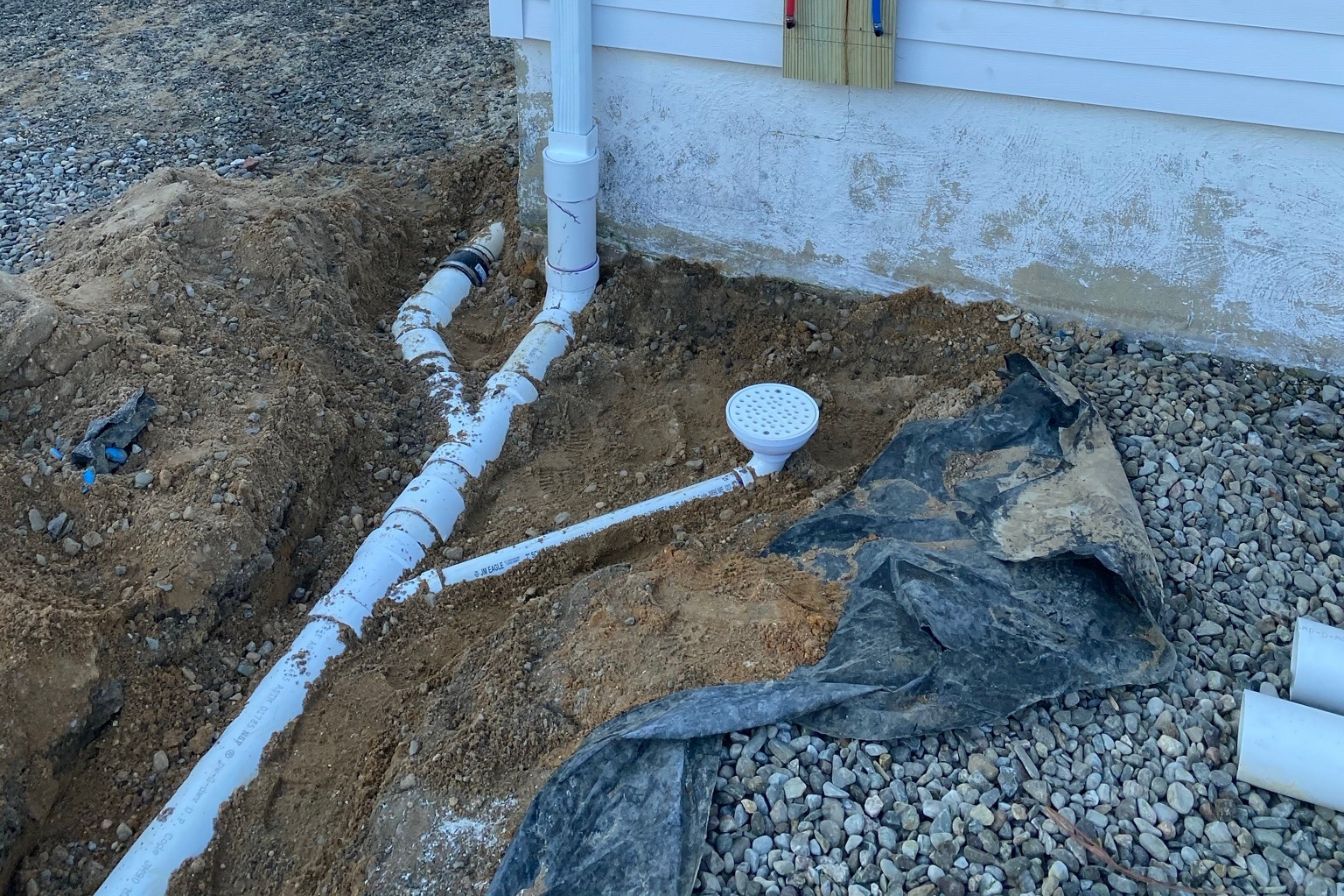 Exterior French drain installation process for basement waterproofing.