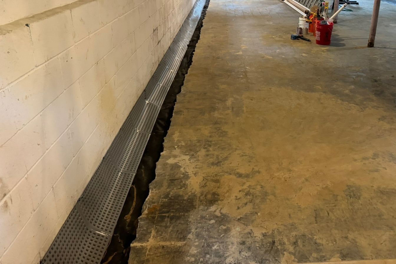 Diagram of an interior french drain system for basement waterproofing.