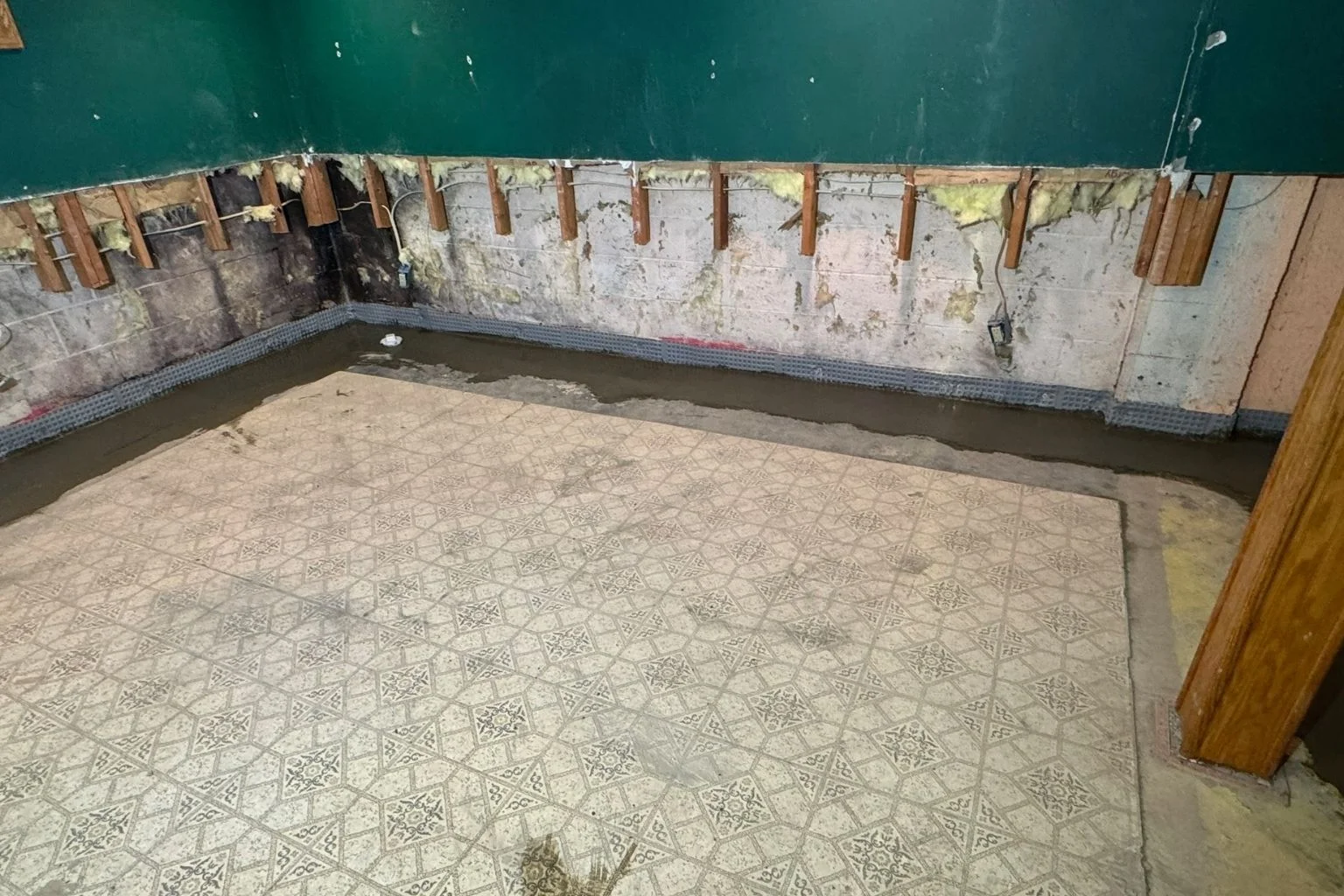 Interior french drain system installed in a basement for waterproofing.