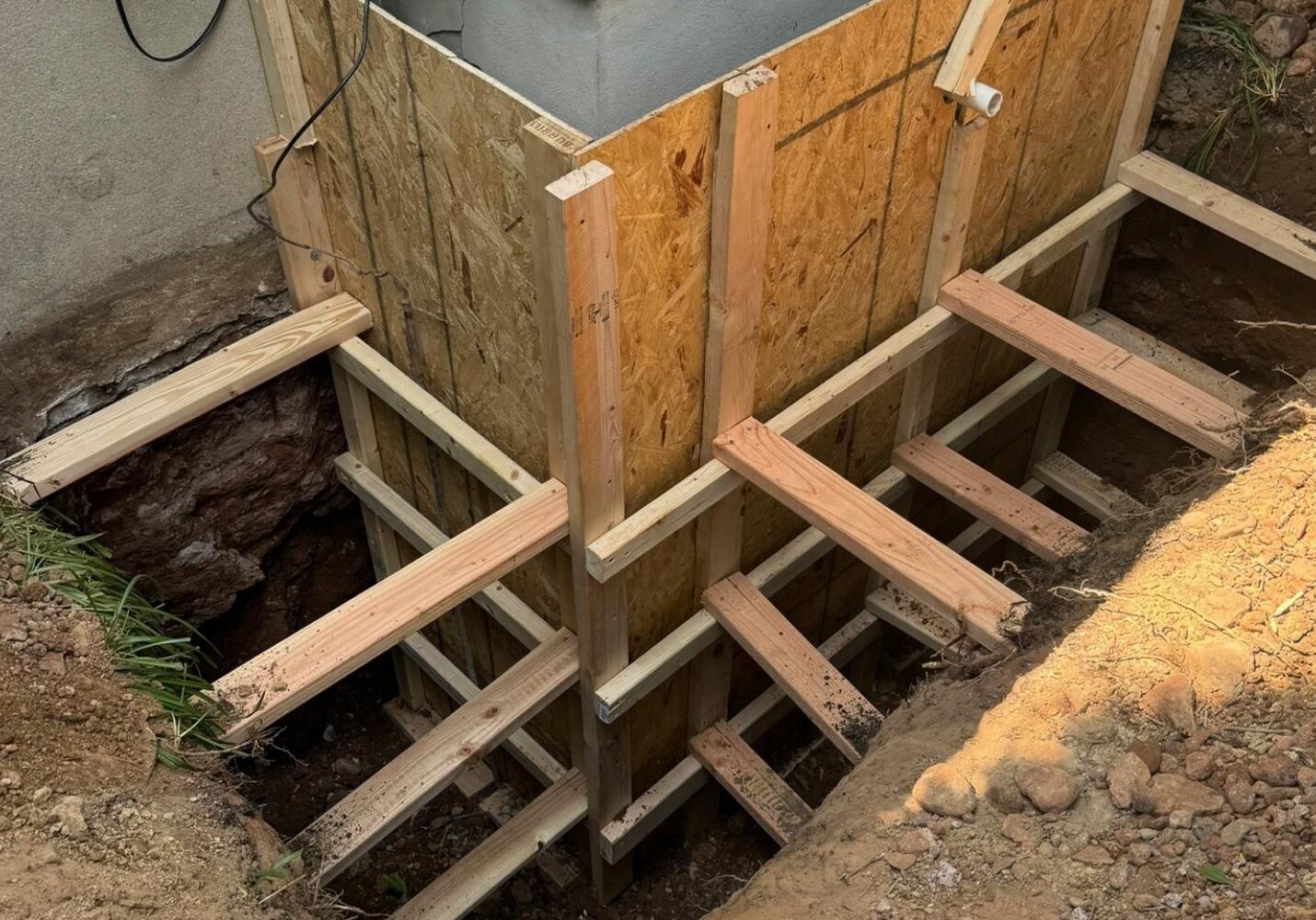Wooden formwork for foundation support during construction, providing structure before concrete is poured.
